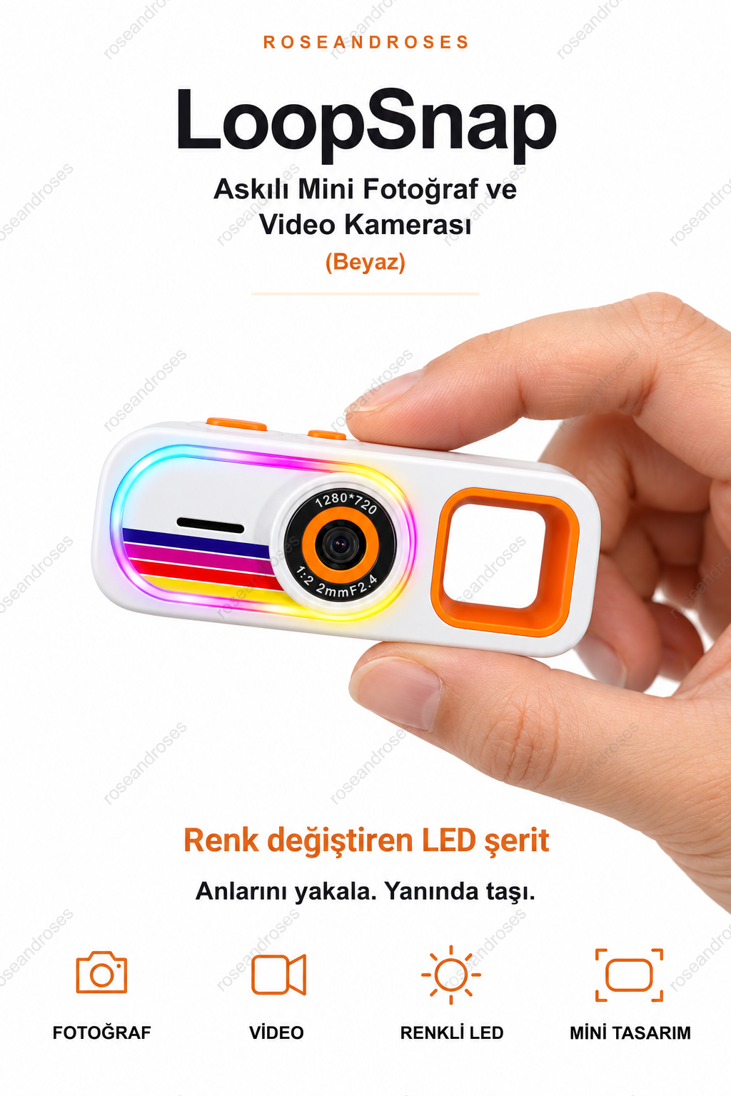 LoopSnap Beyaz mini kamera — parmaklar arasında tutuş ve renk değiştiren LED şerit
